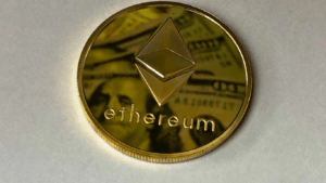 ethereum coin on top of a pile of money