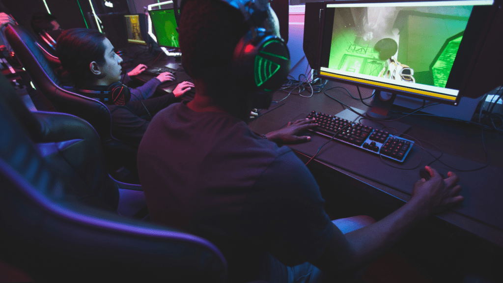 a group of people playing video games in a dark room