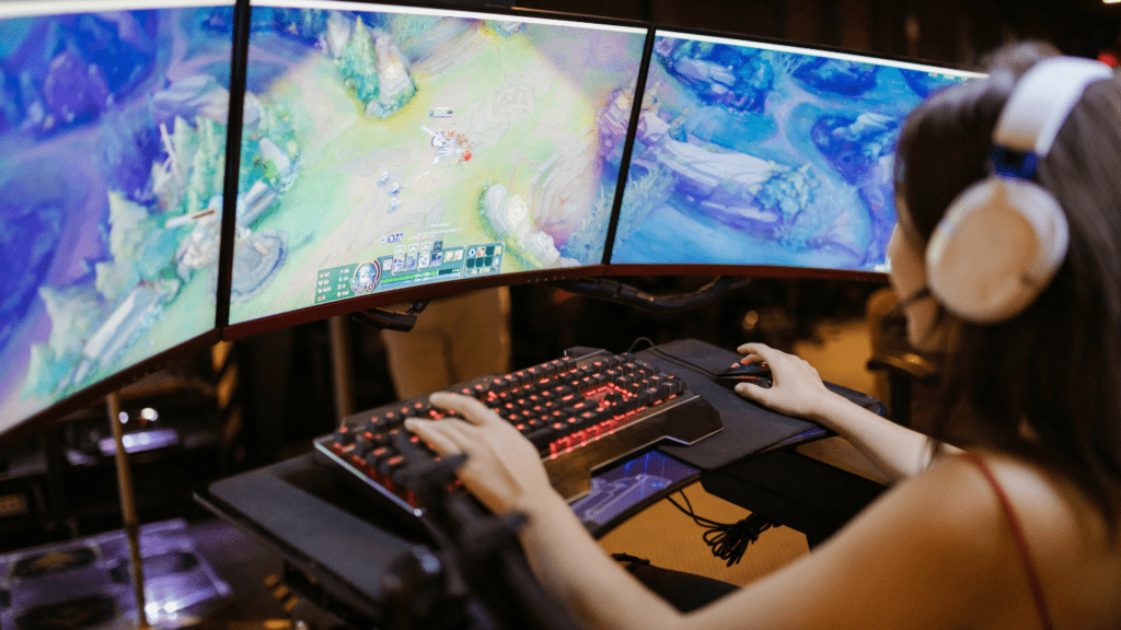 a person playing video games on three monitors