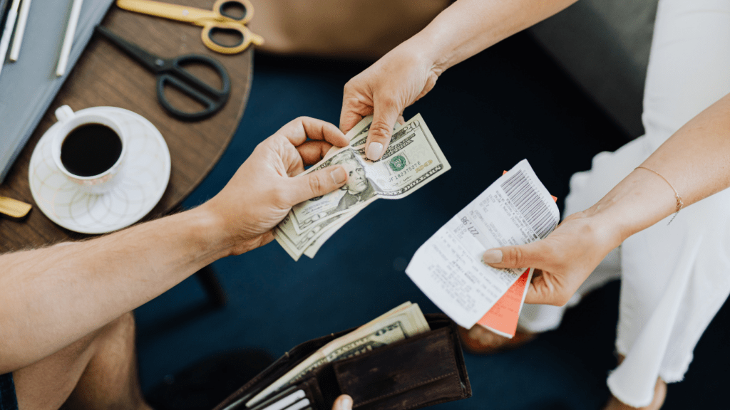 two people handing money to each other