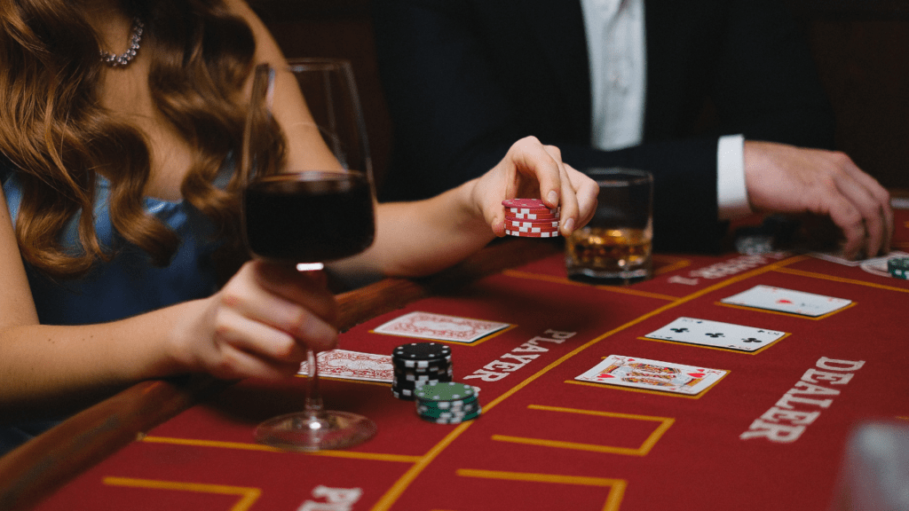 a person in a suit and tie playing cards at a casino table