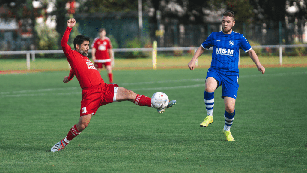 two soccer players in action on the field