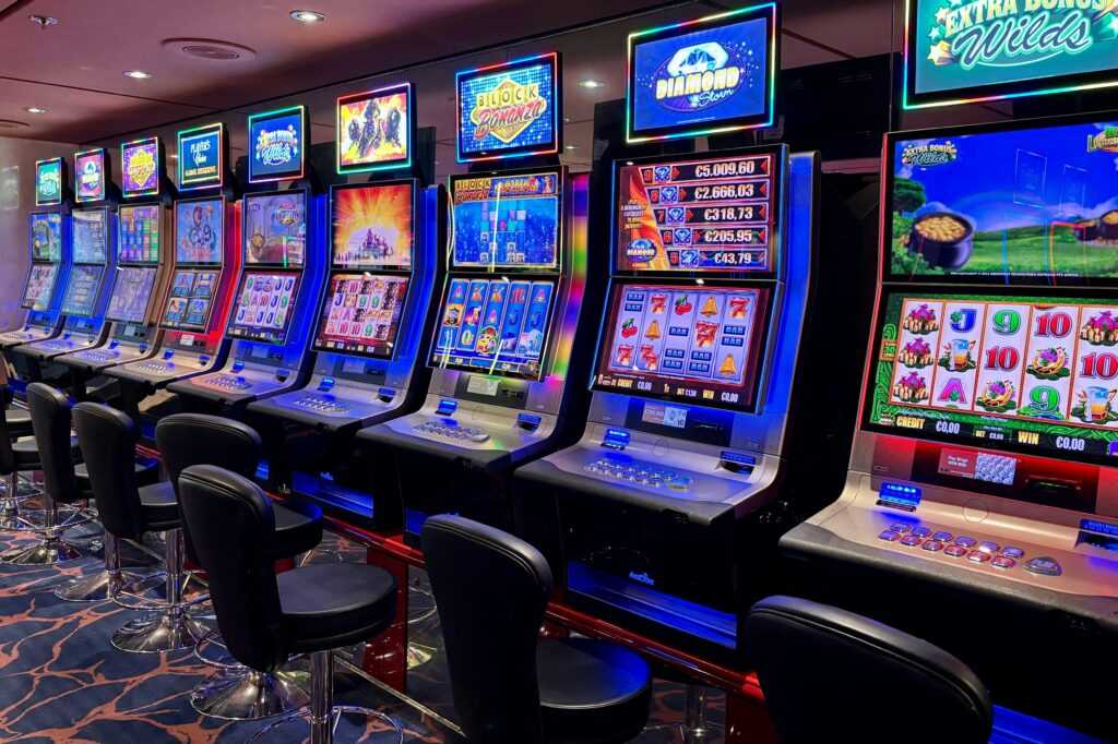 Bright casino slot machines with colorful displays and no people present.